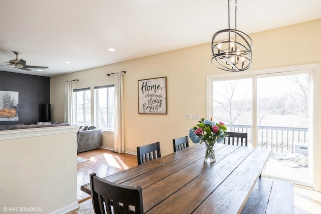 dining space featuring ceiling fan with notable chandelier and recessed lighting