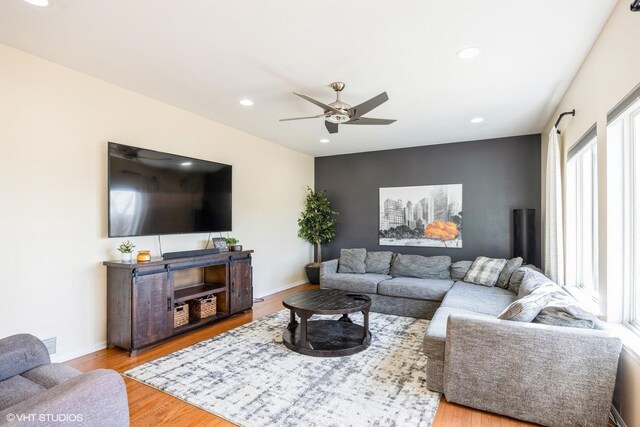 living room featuring ceiling fan, baseboards, wood finished floors, and recessed lighting