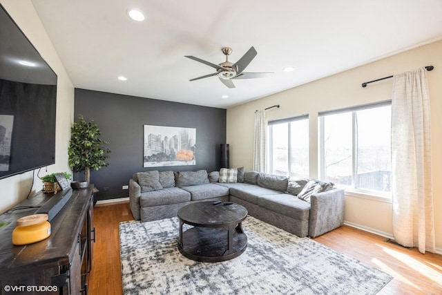 living room featuring recessed lighting, baseboards, and wood finished floors