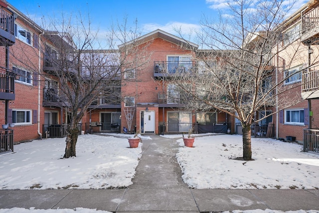 view of front of home with central air condition unit and brick siding