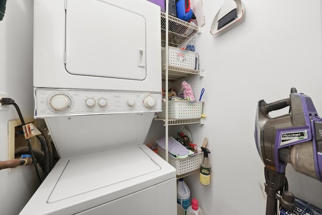 laundry area with stacked washer and dryer and laundry area