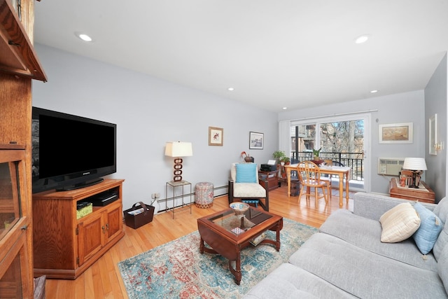 living area with recessed lighting, light wood-type flooring, and a baseboard radiator