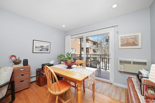 dining space with baseboards, a wall mounted AC, recessed lighting, light wood-style floors, and baseboard heating