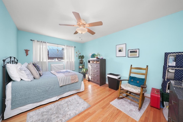 bedroom with light wood finished floors and a ceiling fan