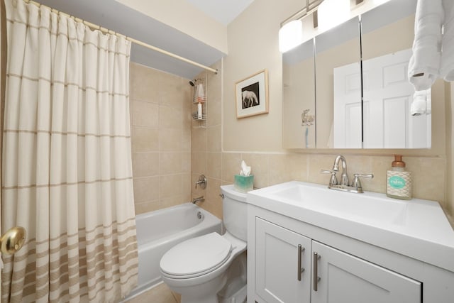 bathroom featuring shower / bath combo with shower curtain, toilet, tile walls, and vanity
