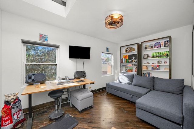 office with a skylight, baseboards, and wood finished floors