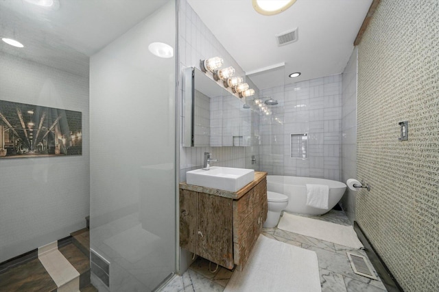 bathroom with visible vents, tile walls, and marble finish floor