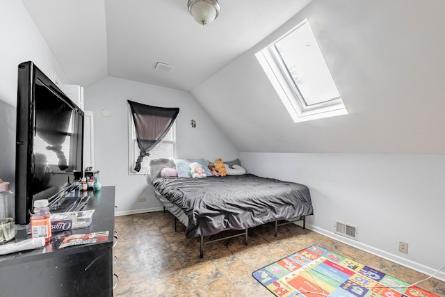 bedroom with visible vents, baseboards, and vaulted ceiling with skylight