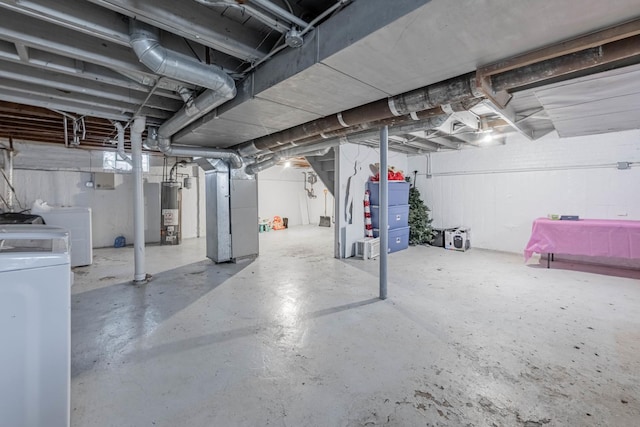 unfinished basement with heating unit, independent washer and dryer, and water heater