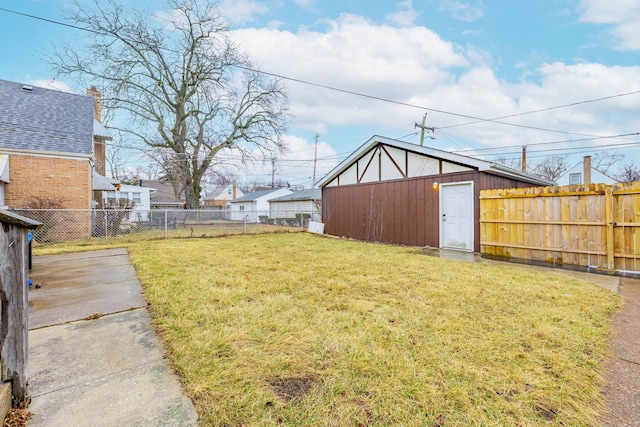 view of yard featuring an outbuilding and a fenced backyard