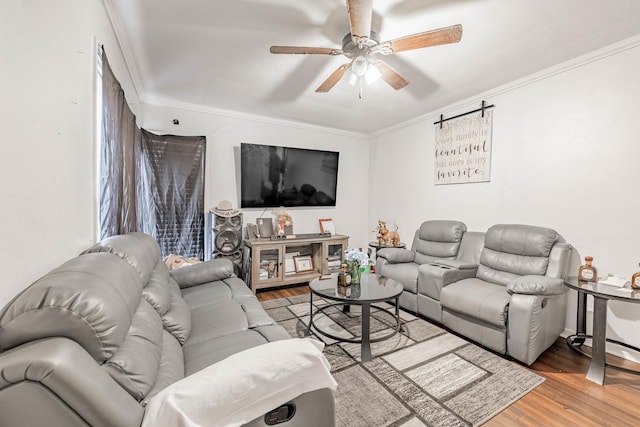 living room featuring a ceiling fan, wood finished floors, and crown molding