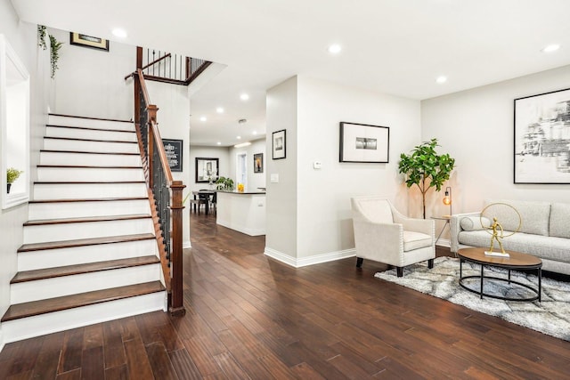 living area featuring stairway, recessed lighting, baseboards, and wood finished floors