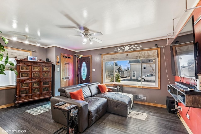 living room featuring crown molding, baseboards, dark wood-style flooring, and ceiling fan