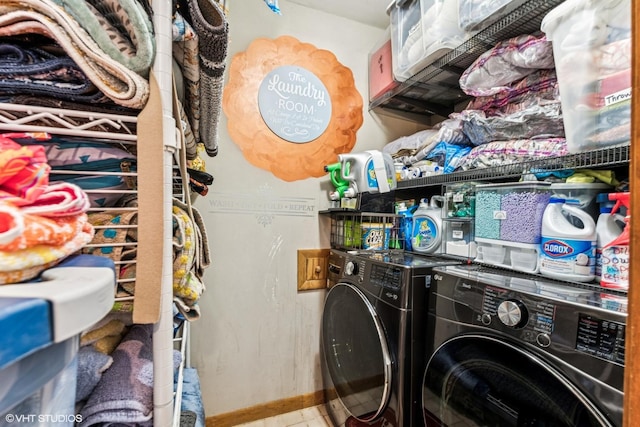 clothes washing area featuring baseboards, independent washer and dryer, and laundry area