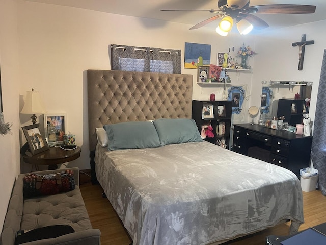 bedroom with a ceiling fan and wood finished floors