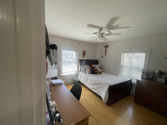 bedroom with light wood-style floors and ceiling fan