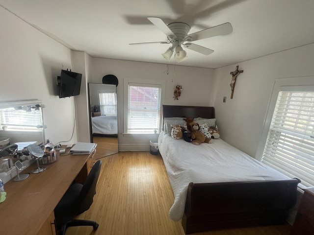 bedroom with light wood-style flooring and a ceiling fan