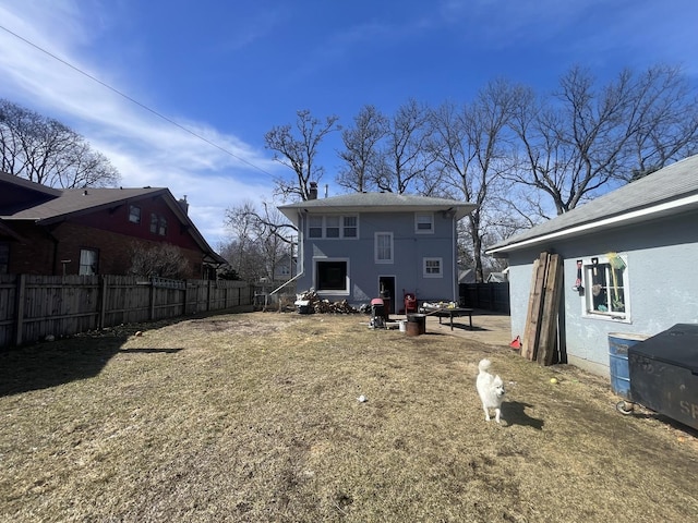 back of house with stucco siding and fence