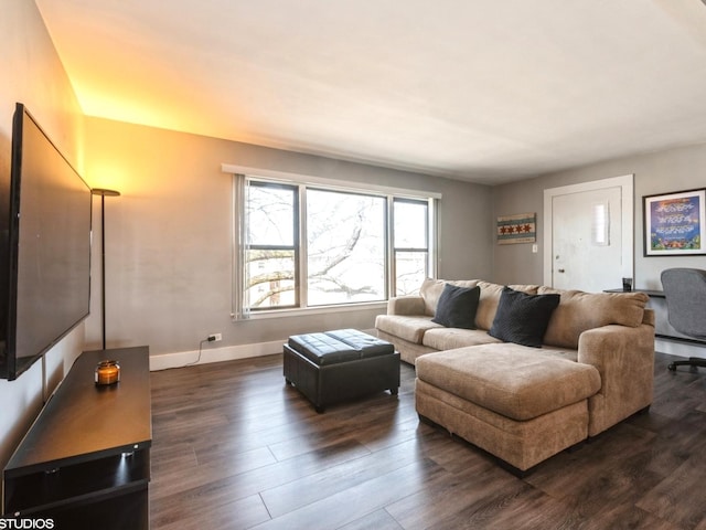 living room featuring baseboards and dark wood finished floors