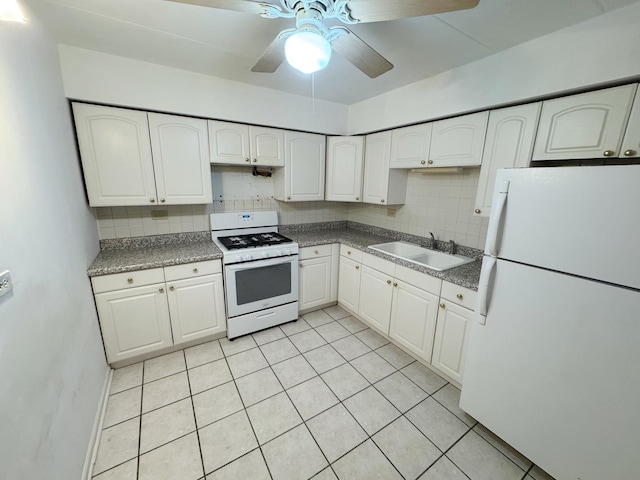 kitchen with decorative backsplash, white cabinets, white appliances, and a sink