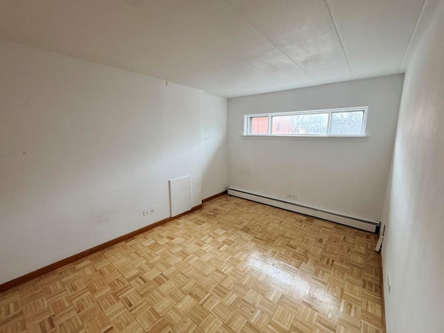 spare room featuring baseboards and a baseboard radiator