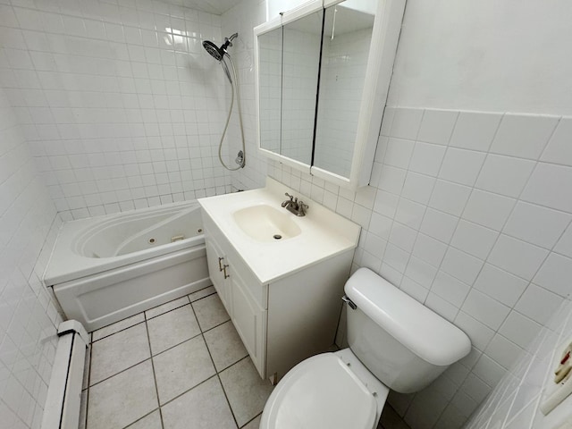 full bath with toilet, vanity, tile patterned floors, tile walls, and a baseboard radiator