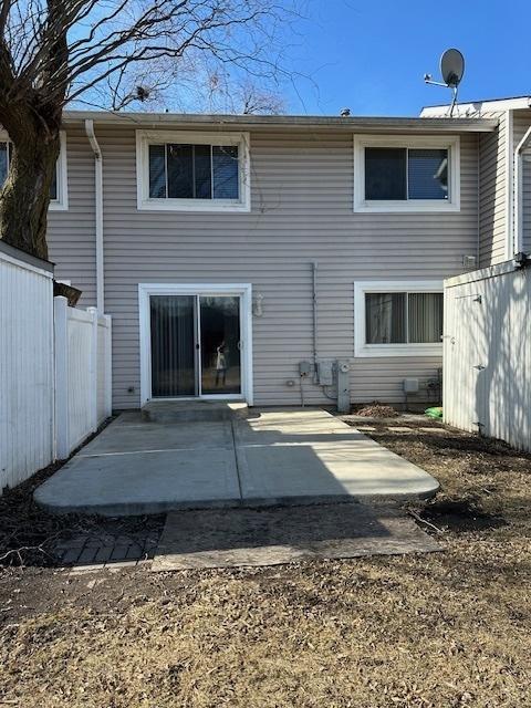 back of house with a patio area and fence