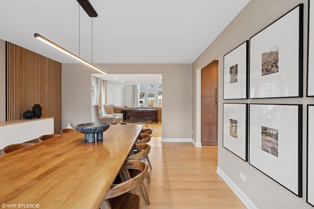 dining area with light wood-type flooring, baseboards, and pool table