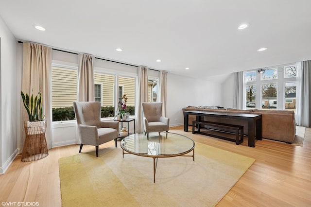 sitting room featuring light wood finished floors, recessed lighting, and a wealth of natural light