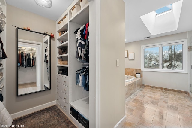 spacious closet with visible vents and a skylight