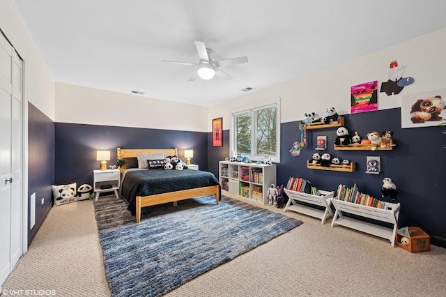 bedroom featuring a closet, visible vents, carpet flooring, and ceiling fan