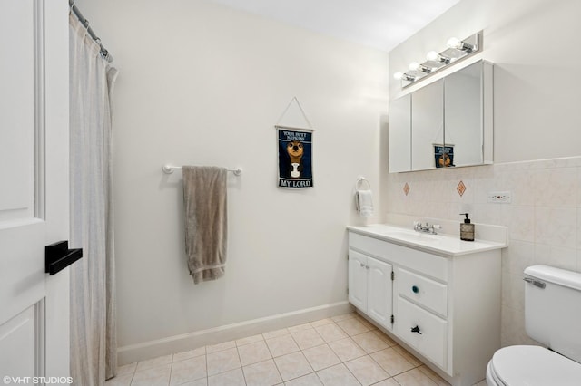 full bath featuring toilet, tile walls, vanity, and tile patterned flooring