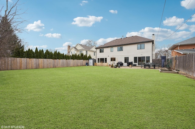 view of yard featuring a patio area and a fenced backyard