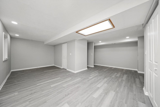 finished below grade area with recessed lighting, baseboards, and wood finished floors