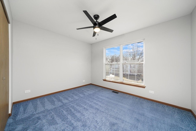 spare room with a ceiling fan, baseboards, visible vents, and carpet floors