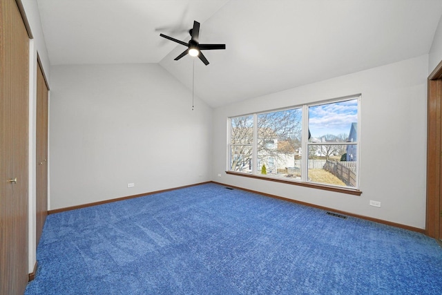 unfurnished bedroom featuring visible vents, baseboards, and vaulted ceiling