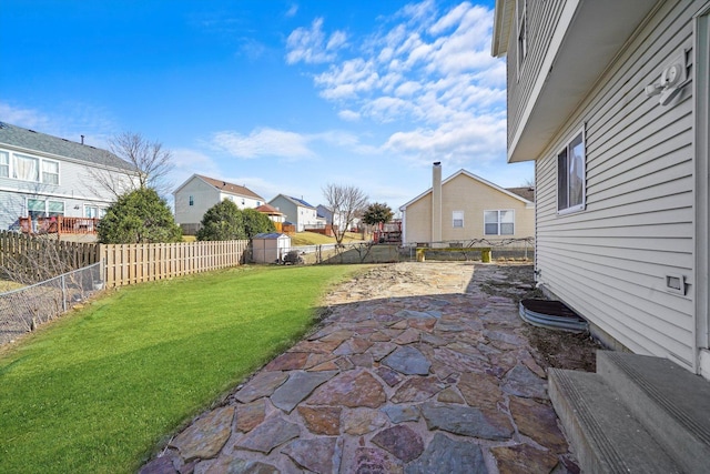 view of yard featuring a fenced backyard, an outdoor structure, and a patio