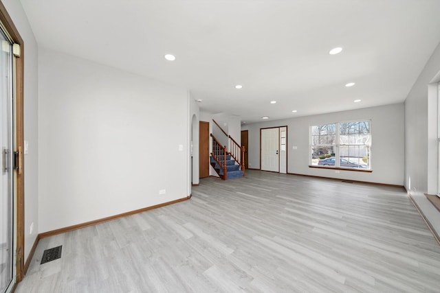 interior space featuring visible vents, light wood-style flooring, recessed lighting, stairway, and baseboards