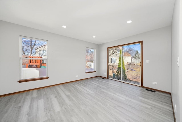 unfurnished room featuring recessed lighting, visible vents, baseboards, and wood finished floors