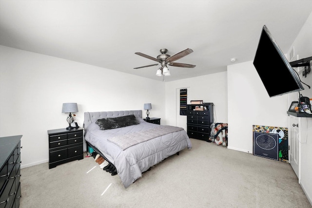 carpeted bedroom featuring baseboards and ceiling fan