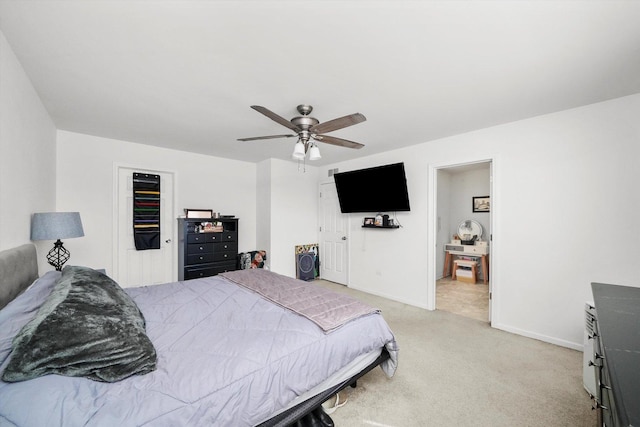 bedroom featuring baseboards, light carpet, and a ceiling fan