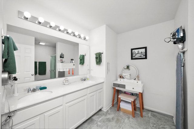 full bathroom featuring a sink, a stall shower, and double vanity