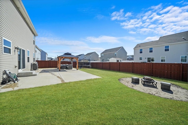 view of yard with a fire pit, a residential view, a gazebo, a fenced backyard, and a patio area