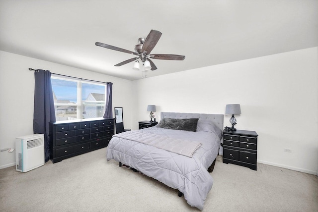 carpeted bedroom featuring a ceiling fan and baseboards