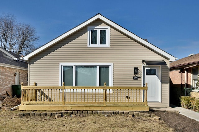 rear view of property featuring a wooden deck