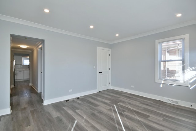 unfurnished room with visible vents, plenty of natural light, and ornamental molding