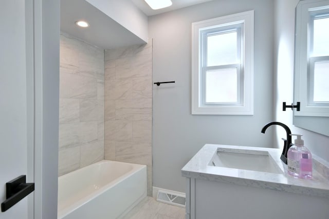 full bath with vanity, visible vents, baseboards, and a wealth of natural light