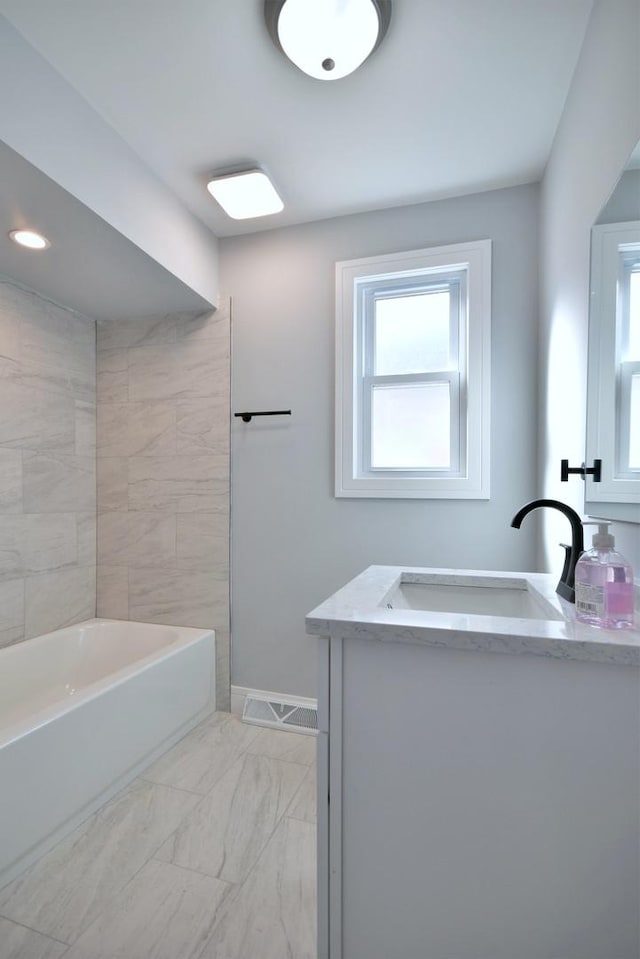 bathroom with vanity, visible vents, baseboards, shower / bath combination, and marble finish floor