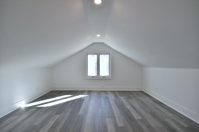 bonus room featuring vaulted ceiling, recessed lighting, baseboards, and dark wood-style flooring