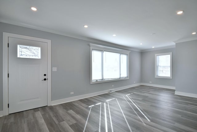 foyer entrance with recessed lighting, crown molding, baseboards, and wood finished floors